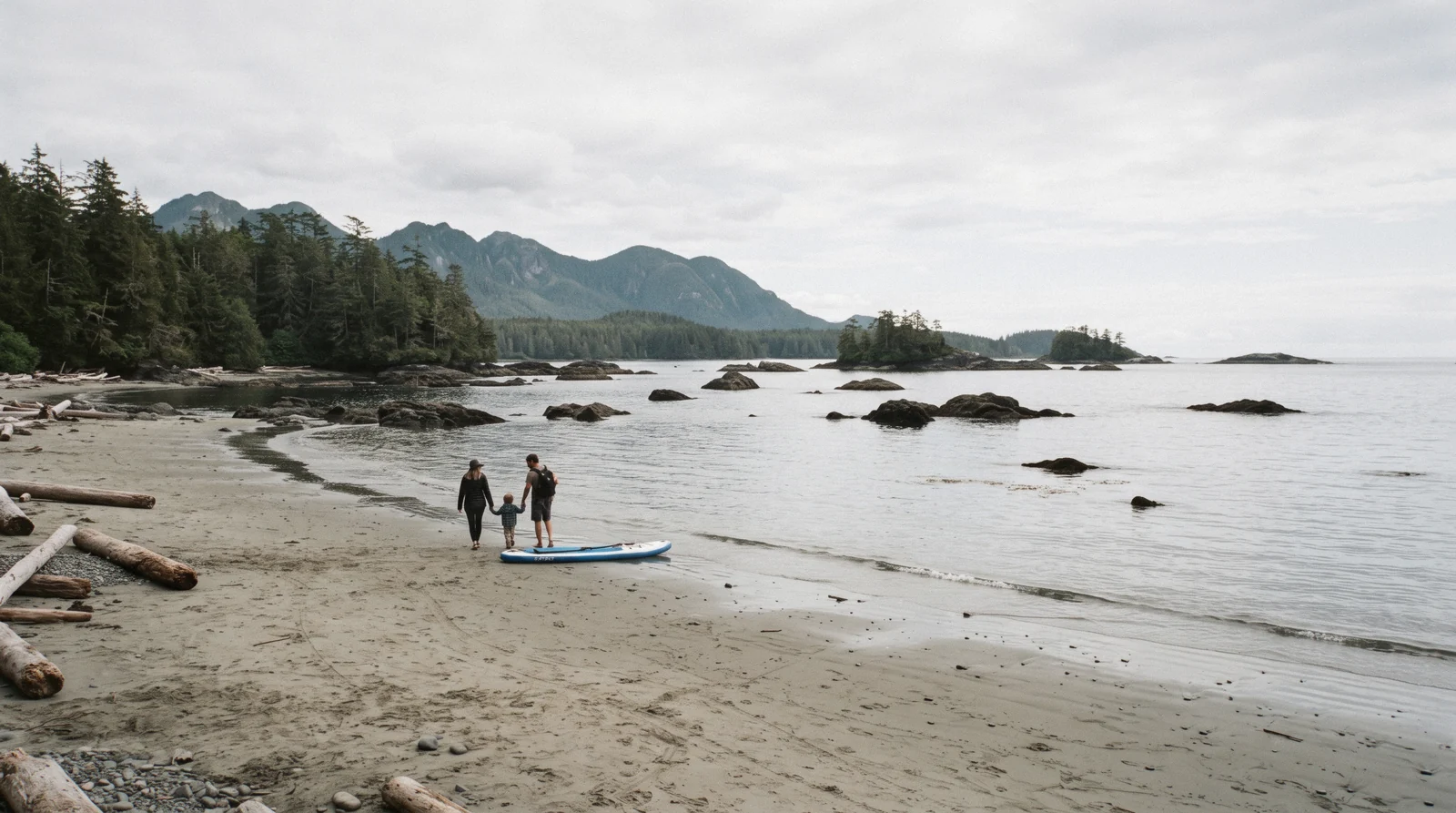 Calm sheltered water at tinwis, formerly Mackenzie Beach, near Tofino, British Columbia, with tidal rocks offshore