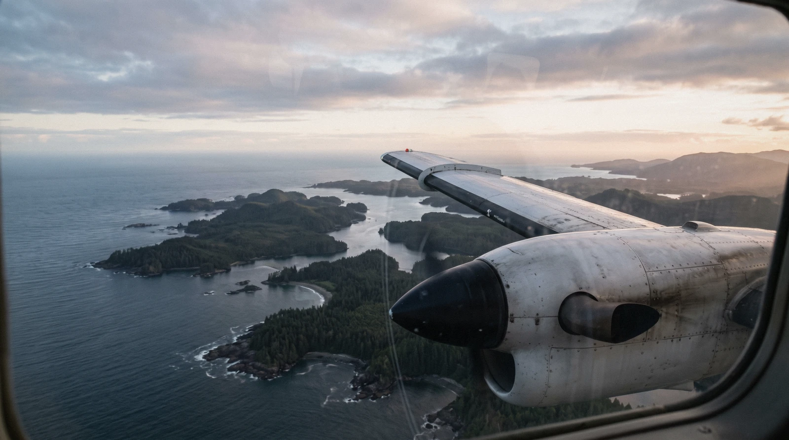 A small commercial aircraft on approach over the coastline near tofino airport