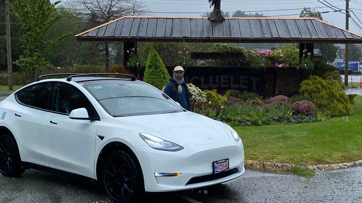Private car on the highway near Cathedral Grove on a Nanaimo to Tofino transfer