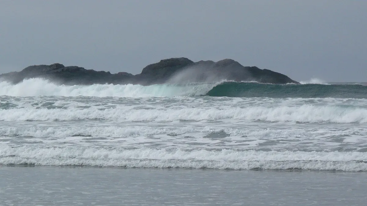 High surf breaking over rocks at Chesterman Beach near Tofino, British Columbia during storm watching season